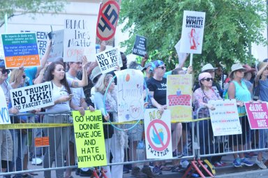 Demonstrators protest at the doors of the Phoenix Convention Center where Donald Trump offers a campain rally